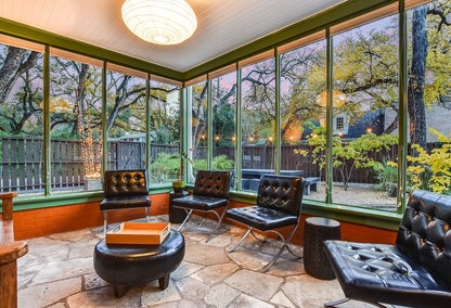 Enclosed luxury patio with leather furniture and garden in Tarrytown, Austin