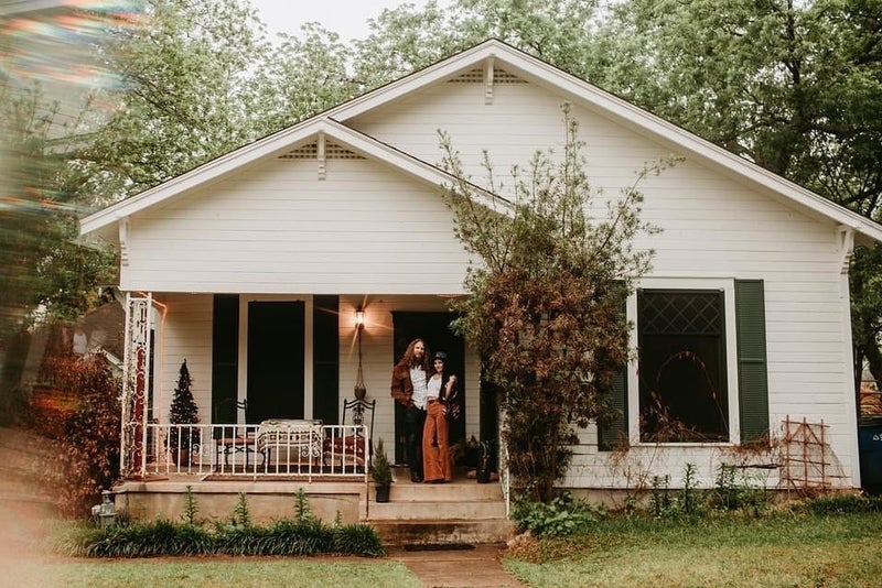 Historic bungalow with charming couple standing on porch, Hyde Park, Austin