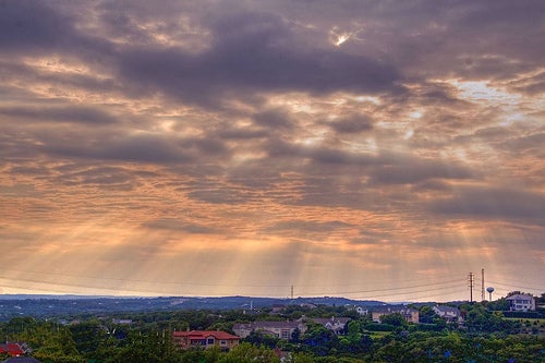 Sunlight breaking through clouds above Bee Cave, Texas